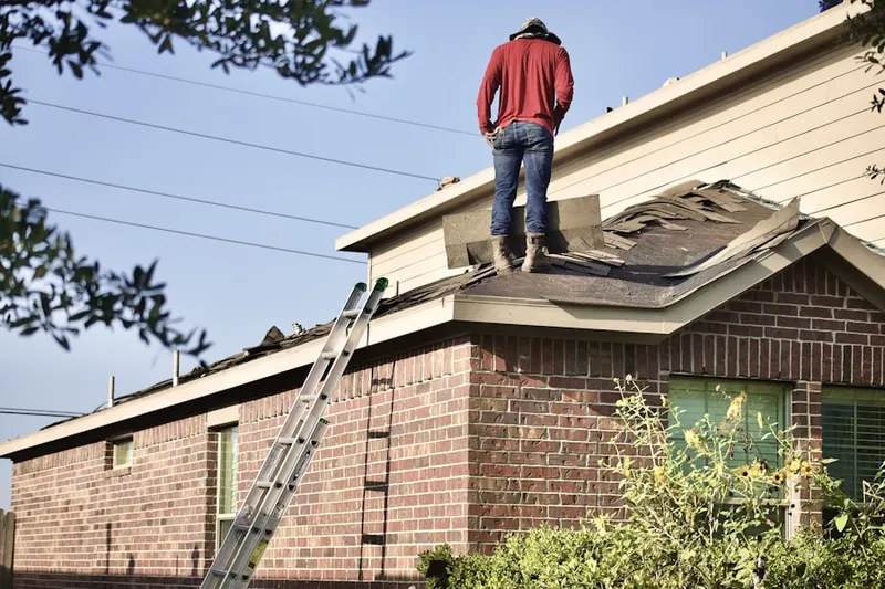 Professional roofer working on a residential roof in Pittsboro